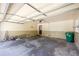 Bright garage interior with a door and electrical garage door opener, a ladder, cleaning supplies, and storage at 4350 Bonaparte Dr, Tucker, GA 30084