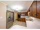 Bright kitchen with stainless steel refrigerator, classic oak cabinets, and tile flooring at 4350 Bonaparte Dr, Tucker, GA 30084