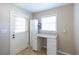 Bright laundry room features a utility sink, storage cabinet, counter, and outdoor access at 4350 Bonaparte Dr, Tucker, GA 30084
