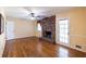 Inviting living room featuring a brick fireplace and beautiful hardwood floors at 4350 Bonaparte Dr, Tucker, GA 30084