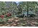 Quaint home nestled amongst mature trees, featuring a red dumpster at 1164 Oldfield Rd, Decatur, GA 30030