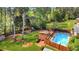 Aerial view showcasing the backyard pool, deck, and play area amid mature trees and landscaping at 1834 Kimberly Sw Dr, Marietta, GA 30008