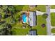 Aerial view of the property featuring a backyard pool, manicured lawn, and mature trees at 1834 Kimberly Sw Dr, Marietta, GA 30008