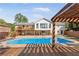 Gorgeous backyard featuring an in-ground pool, deck, and pergola-covered seating area at 1834 Kimberly Sw Dr, Marietta, GA 30008