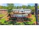 Backyard view of an in-ground pool with a wooden deck and lush landscaping with a house view at 1834 Kimberly Sw Dr, Marietta, GA 30008
