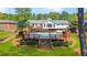 Expansive backyard featuring a pool, wooden deck, patio area, and mature trees at 1834 Kimberly Sw Dr, Marietta, GA 30008