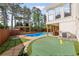 Backyard featuring an in-ground pool, putting green, and outdoor seating area for relaxation and recreation at 1834 Kimberly Sw Dr, Marietta, GA 30008