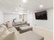 Finished basement with a plush sectional sofa, recessed lighting, and mounted television at 1834 Kimberly Sw Dr, Marietta, GA 30008