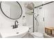 Modern bathroom features a glass-enclosed shower and a black round mirror at 1834 Kimberly Sw Dr, Marietta, GA 30008
