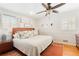 Cozy bedroom featuring a ceiling fan, a large bed with decorative pillows and natural light at 1834 Kimberly Sw Dr, Marietta, GA 30008