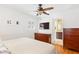 Bedroom featuring wood floors, a ceiling fan, and access to an ensuite bathroom at 1834 Kimberly Sw Dr, Marietta, GA 30008