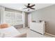 Comfortable bedroom featuring a large window, a white dresser, and neutral paint at 1834 Kimberly Sw Dr, Marietta, GA 30008