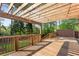Wooden deck with a pergola offers a great place for entertaining overlooking the backyard at 1834 Kimberly Sw Dr, Marietta, GA 30008