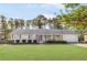 Charming white brick ranch-style home with a well-manicured lawn and mature trees at 1834 Kimberly Sw Dr, Marietta, GA 30008