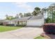 Beautiful ranch-style home with a welcoming front porch, manicured lawn, and attached garage at 1834 Kimberly Sw Dr, Marietta, GA 30008