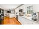 Open-concept kitchen with stainless appliances, white cabinetry, and hardwood floors at 1834 Kimberly Sw Dr, Marietta, GA 30008