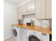Functional laundry room with updated washer, dryer, and white cabinets at 1834 Kimberly Sw Dr, Marietta, GA 30008