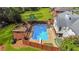 Aerial view of a private backyard featuring a sparkling pool, deck, and lush landscaping at 1834 Kimberly Sw Dr, Marietta, GA 30008