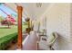 Inviting front porch with cozy seating, hanging flowers, and decorative wooden support beams at 1834 Kimberly Sw Dr, Marietta, GA 30008