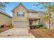 Charming two-story home featuring a two-car garage, manicured shrubs, and a cozy covered front porch entrance at 2513 Shropshire Pl, Mcdonough, GA 30253