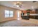 Open-concept kitchen with stainless steel appliances, a center island, dark wood cabinets, and a view of the dining area at 2513 Shropshire Pl, Mcdonough, GA 30253