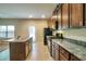 Modern kitchen with an island, stainless steel appliances, and dark wood cabinets with lots of counter space at 2513 Shropshire Pl, Mcdonough, GA 30253