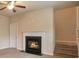 Cozy living room with a fireplace and access to the second floor stairs at 2513 Shropshire Pl, Mcdonough, GA 30253