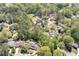 An aerial view of the neighborhood showcasing lush greenery, mature trees, and other beautiful homes at 4030 Muirfield Ln, Marietta, GA 30068