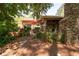 This backyard has an outdoor stone fireplace, covered patio with seating, mature trees and landscaping at 4030 Muirfield Ln, Marietta, GA 30068