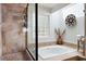 Elegant bathroom featuring a soaking tub, travertine tile shower, and stylish decor at 4030 Muirfield Ln, Marietta, GA 30068
