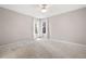 Bright bedroom with neutral carpet and walls with windows covered by curtains at 4030 Muirfield Ln, Marietta, GA 30068