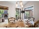 Dining room featuring an outdoor fireplace view, wood table and chairs and modern light fixture at 4030 Muirfield Ln, Marietta, GA 30068