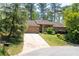 Stunning single Gathering home featuring a beautiful driveway, attached garage, and gorgeous landscaping at 4030 Muirfield Ln, Marietta, GA 30068