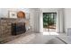 Close-up of the stone fireplace and sliding glass door in the main bedroom at 4030 Muirfield Ln, Marietta, GA 30068