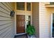 Close-up of front door with sidelight and transom windows with a decorative exterior light at 4030 Muirfield Ln, Marietta, GA 30068