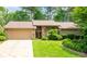 Charming single-Gathering home featuring an attached garage, lush landscaping, and stone accents at 4030 Muirfield Ln, Marietta, GA 30068