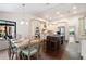 Kitchen open to the dining area, island with stools, stainless appliances and hardwood floors at 4030 Muirfield Ln, Marietta, GA 30068