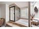 Bright and modern main bathroom features a soaking tub and walk-in shower at 4030 Muirfield Ln, Marietta, GA 30068