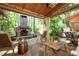 Outdoor patio with stone fireplace, furniture, and outdoor kitchen area at 4030 Muirfield Ln, Marietta, GA 30068