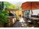 Outdoor kitchen and dining area with built-in grill, stone accents, and patio at 4030 Muirfield Ln, Marietta, GA 30068