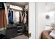 Bright walk-in closet with shelving and storage; leads to bathroom with decorative wall art at 4030 Muirfield Ln, Marietta, GA 30068