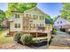 The backyard features a large deck, green lawn, mature trees, and a light green house at 4157 Town Branch Ct Sw, Covington, GA 30014