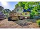 The backyard features a large deck, green lawn, mature trees, and a light green house at 4157 Town Branch Ct Sw, Covington, GA 30014