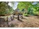 A spacious backyard with well-maintained lawn, cozy fire pit, a large deck and the home's exterior at 4157 Town Branch Ct Sw, Covington, GA 30014
