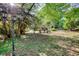 A spacious backyard with well-maintained lawn, cozy fire pit, and a view of the home's exterior at 4157 Town Branch Ct Sw, Covington, GA 30014