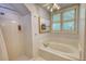 Clean bathroom featuring a shower and a soaking tub, and natural light at 4157 Town Branch Ct Sw, Covington, GA 30014
