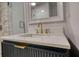 Bathroom features a marble shower, sleek vanity with gold fixtures and a framed mirror, perfect for relaxation at 4157 Town Branch Ct Sw, Covington, GA 30014