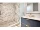 Bathroom with marble subway tile shower and vanity with a white countertop and gold fixtures at 4157 Town Branch Ct Sw, Covington, GA 30014
