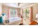 Charming bedroom featuring pink and white curtains and accent pillows, creating a cozy and stylish retreat at 4157 Town Branch Ct Sw, Covington, GA 30014
