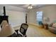 Cozy bedroom featuring neutral walls, patterned carpet, ceiling fan, and a comfortable sitting area at 4157 Town Branch Ct Sw, Covington, GA 30014